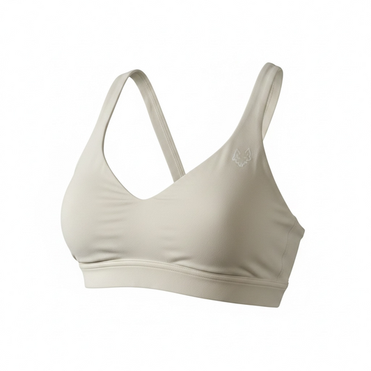 Women's beige SAVAG3 HERA™ performance sports bra featuring buttery-soft fabric, supportive fit, and premium activewear design for gym training and everyday wear.
