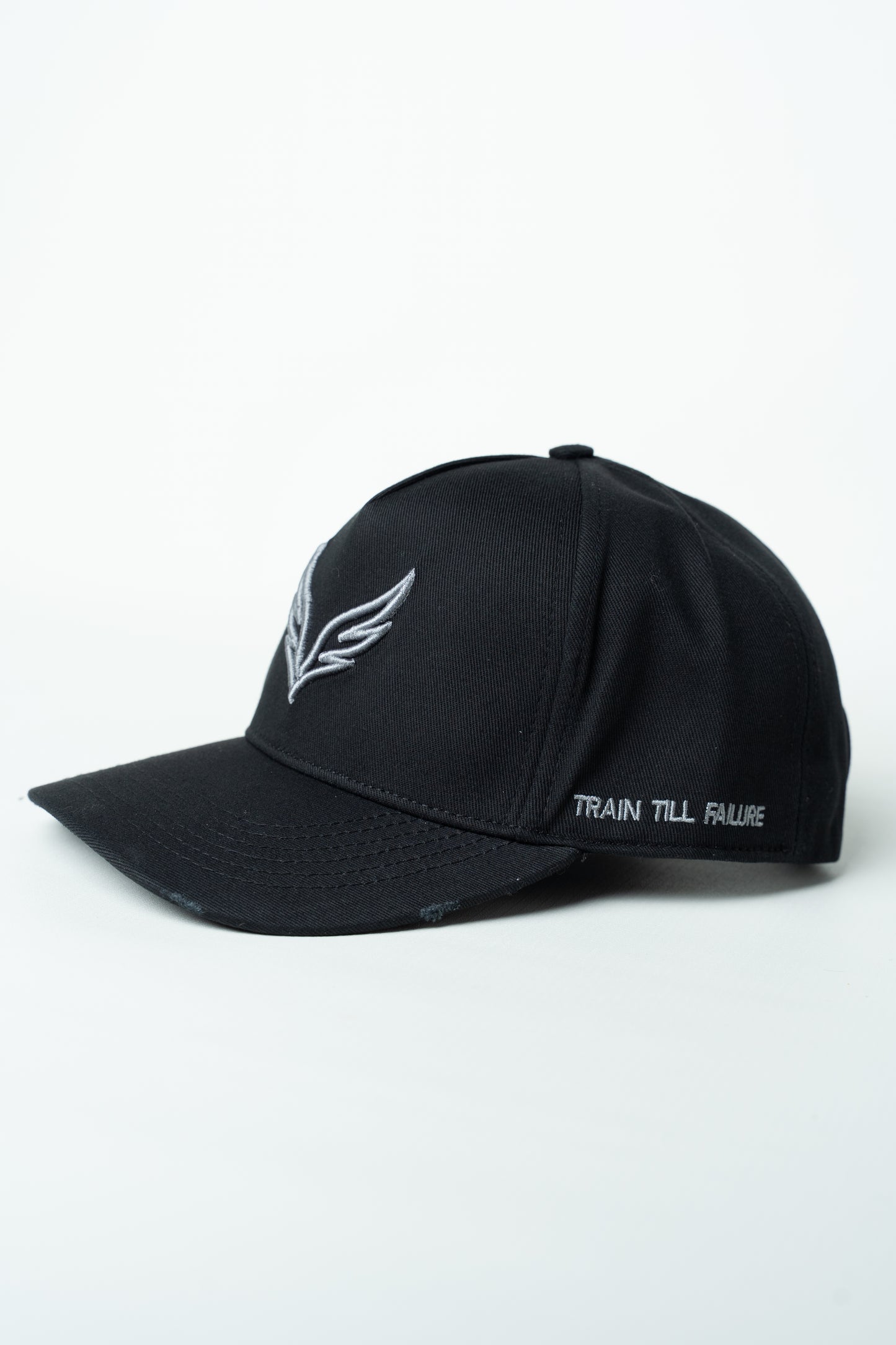 Side view of the SAVAG3 Vintage Cotton Cap featuring the embroidered "Train Till Failure" slogan and adjustable fit.