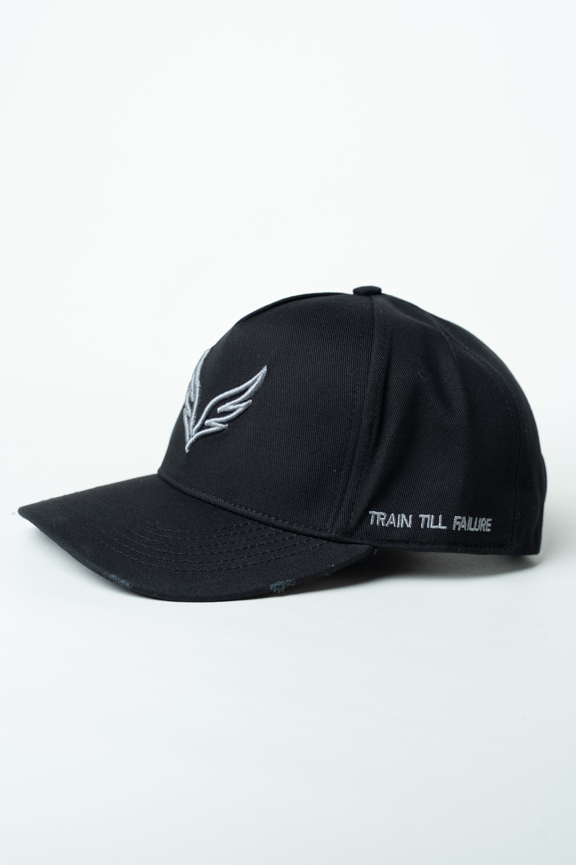 Side view of the SAVAG3 Vintage Cotton Cap featuring the embroidered "Train Till Failure" slogan and adjustable fit.