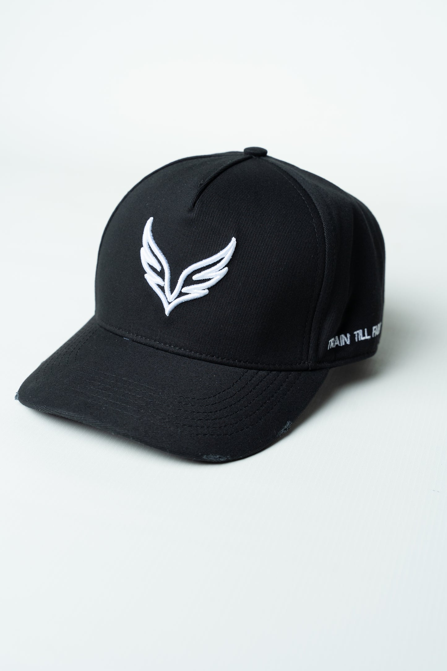 Side view of the SAVAG3 Vintage Cotton Cap featuring the embroidered "Train Till Failure" slogan and adjustable fit.